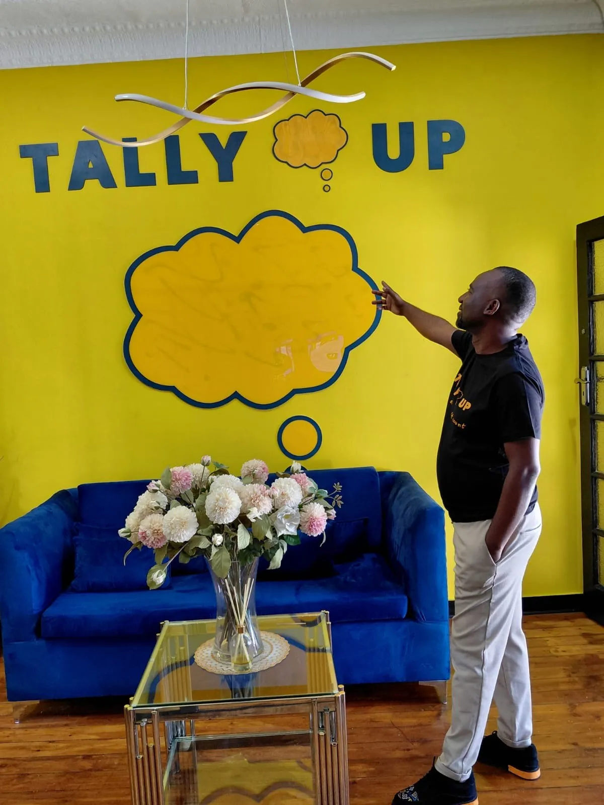 A Tally Up tutor at the yellow Tally Up wall